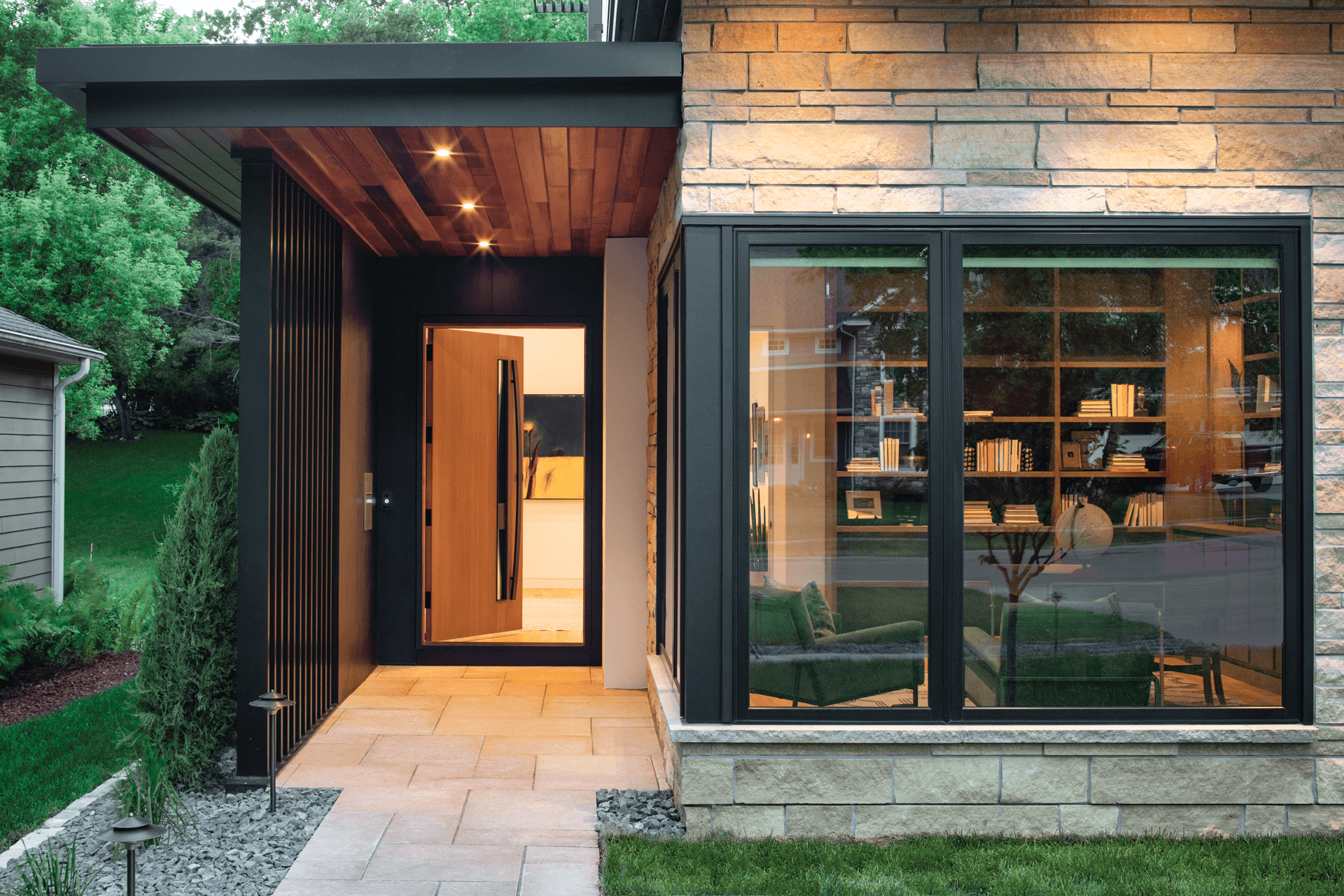 The outside of a home featuring Marvin Ultimate picture windows.